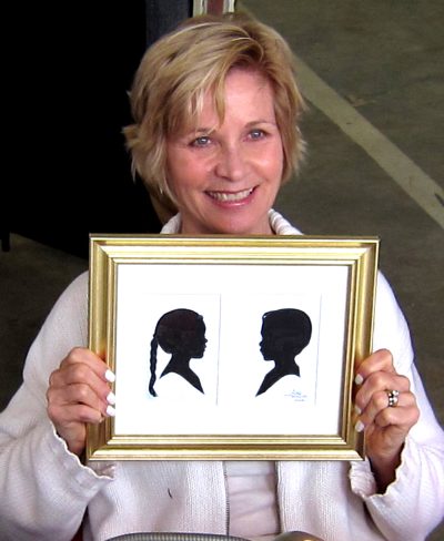 Artist Holding Silhouette of Siblings